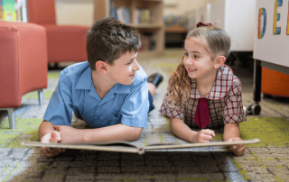 Two St Mark's Primary School Drummoyne students sharing a love of reading in the school's library